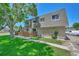 Townhouse exterior view showcasing landscaping and parking at 6885 E Arizona Avenue # D, Denver, CO 80224
