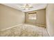 Bright and airy bedroom with neutral carpeting and ceiling fan at 6885 E Arizona Avenue # D, Denver, CO 80224