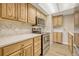 Modern kitchen with stainless steel appliances and light wood cabinets at 6885 E Arizona Avenue # D, Denver, CO 80224