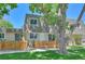A charming townhome with a wooden fence and mature tree at 6885 E Arizona Avenue # D, Denver, CO 80224