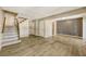 Open living area with wood-look floors and view of the staircase at 6885 E Arizona Avenue # D, Denver, CO 80224