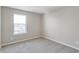 Bright bedroom with a large window and carpet at 18097 Dandy Brush Ln, Parker, CO 80134