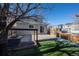 Spacious backyard with patio, grassy area, and wood fence at 9396 Garfield St, Thornton, CO 80229