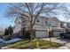 Two-story townhome with attached garage and landscaped front yard at 9396 Garfield St, Thornton, CO 80229