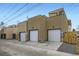 Rear view of attached garages with ample parking space at 2313 S High St, Denver, CO 80210