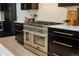 Stainless steel range and oven with dark cabinetry at 1251 Winslow Cir, Longmont, CO 80504