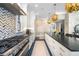 Modern kitchen with herringbone backsplash and large island at 655 N Humboldt St, Denver, CO 80218