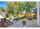 Landscaped backyard with patio, seating area, and wood fence at 655 N Humboldt St, Denver, CO 80218