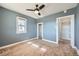 Bedroom with built-in shelving and neutral carpeting at 2523 W Wesley Ave, Denver, CO 80219