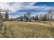 Large backyard with grassy area and home view at 7000 S Sheridan Blvd, Littleton, CO 80128