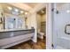 Bathroom with a large vanity, walk-in shower, and separate toilet area at 7000 S Sheridan Blvd, Littleton, CO 80128