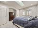 Bright bedroom with a double bed, dresser, and window with shutters at 7000 S Sheridan Blvd, Littleton, CO 80128
