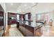 Gourmet kitchen boasts dark wood cabinetry, granite island, and stainless steel appliances at 7000 S Sheridan Blvd, Littleton, CO 80128