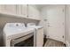 Laundry room with washer, dryer, and cabinets at 7000 S Sheridan Blvd, Littleton, CO 80128