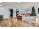 Open living area with hardwood floors, vaulted ceiling, and Christmas tree at 7000 S Sheridan Blvd, Littleton, CO 80128