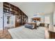 Main bedroom with hardwood floors, built-in shelving, and ensuite bathroom at 7000 S Sheridan Blvd, Littleton, CO 80128
