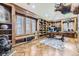 Spacious office with built-in wooden shelving and hardwood floors at 7000 S Sheridan Blvd, Littleton, CO 80128