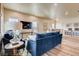 Spacious living room with navy blue sofa and hardwood floors at 830 W 128Th Pl, Westminster, CO 80234