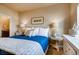 Bedroom with blue bedding, nightstands, and decorative accents at 830 W 128Th Pl, Westminster, CO 80234