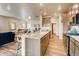Island kitchen with granite countertops and light wood cabinets at 830 W 128Th Pl, Westminster, CO 80234