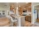 Open concept kitchen with granite island and light cabinets at 830 W 128Th Pl, Westminster, CO 80234