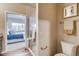 Bathroom with toilet, shower, and view into bedroom at 830 W 128Th Pl, Westminster, CO 80234
