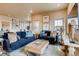 Living room with comfortable navy blue sofas and large windows at 830 W 128Th Pl, Westminster, CO 80234