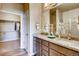 Double vanity bathroom with granite countertop and access to a walk-in closet at 830 W 128Th Pl, Westminster, CO 80234