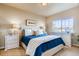 Bedroom with blue bedding, nightstands, and large window at 830 W 128Th Pl, Westminster, CO 80234