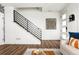 Modern staircase with sleek metal railing and hardwood floors at 10864 Lyric St, Lone Tree, CO 80134