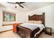 Spacious bedroom with a large bed, window seat, and ceiling fan at 28192 Shadow Mountain Dr, Conifer, CO 80433