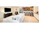 Living area features a sectional sofa, a wood-burning stove, and kitchen access at 28192 Shadow Mountain Dr, Conifer, CO 80433