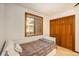 Small bedroom with a daybed, built in drawers, and a closet at 28192 Shadow Mountain Dr, Conifer, CO 80433
