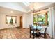Small dining area with terracotta tile floors and a view of the woods at 28192 Shadow Mountain Dr, Conifer, CO 80433
