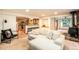 Open living room with a comfy sectional sofa and a view into the kitchen at 28192 Shadow Mountain Dr, Conifer, CO 80433