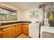 Laundry room with washer, dryer, and additional storage at 28192 Shadow Mountain Dr, Conifer, CO 80433