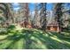 Secluded home nestled among tall trees on a grassy lot at 28192 Shadow Mountain Dr, Conifer, CO 80433