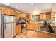 Modern kitchen with wood cabinets, stainless steel appliances, and granite countertops at 28192 Shadow Mountain Dr, Conifer, CO 80433