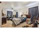 Bedroom with a bed, musical instruments, and window curtains at 7496 Krameria St, Commerce City, CO 80022