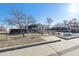 Front view of a ranch home with a yard and sidewalk at 7496 Krameria St, Commerce City, CO 80022