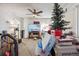 Living room with a TV, Christmas tree, and pet carrier at 7496 Krameria St, Commerce City, CO 80022