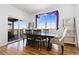Dining area with hardwood floors and sliding door to deck at 9785 Mount Kataka Pt, Littleton, CO 80125