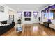 Living room with hardwood floors, fireplace, and large windows at 9785 Mount Kataka Pt, Littleton, CO 80125