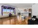 Spacious living room with hardwood floors and kitchen view at 9785 Mount Kataka Pt, Littleton, CO 80125