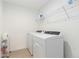 Convenient laundry room with washer, dryer, and shelving at 9785 Mount Kataka Pt, Littleton, CO 80125
