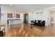 Open concept kitchen and living area with hardwood floors, stainless steel appliances, and island at 9785 Mount Kataka Pt, Littleton, CO 80125