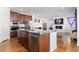 Open kitchen with island, granite countertops, and stainless steel appliances at 9785 Mount Kataka Pt, Littleton, CO 80125