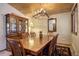 Rustic dining room featuring a wood table, antler chandelier, and wood cabinetry at 11608 Apache Trl, Conifer, CO 80433