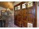 Inviting entryway with stained-glass doors and brick accent wall at 11608 Apache Trl, Conifer, CO 80433