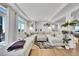 Bright living room featuring a sectional sofa and large windows at 4072 N Rome St, Aurora, CO 80019